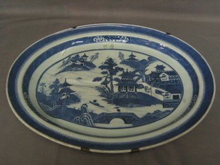 A 19th Century Nankin blue and white oval porcelain meat dish decorated temples 15"