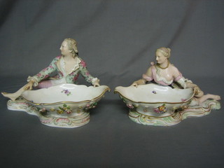 A pair of 19th Century Meissen porcelain sweet meat dishes decorated a reclining lady and gentleman (gentleman toes chipped) f), the base with crossed sword mark and impressed 2863S, the ladies base impressed 2858 8" (ladies toes chipped)