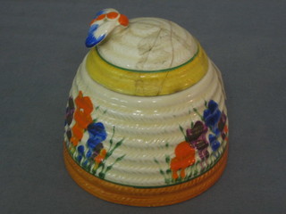 A Clarice Cliff crocus pattern, beehive shaped preserve jar and cover (lid f and r) 3"