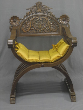 A carved oak X framed chair with bar back