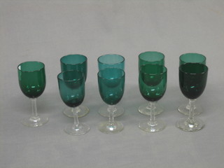9 various 19th Century green glass wine glasses with clear glass stems