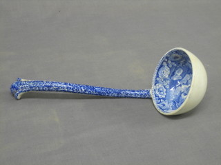 A 19th Century blue and white pottery soup ladle, the bowl decorated a country scene with Church and cottage