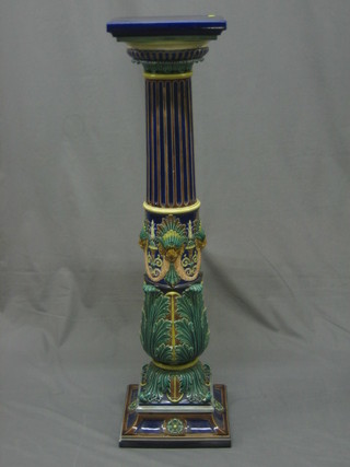 A Minton style Majolica column jardiniere stand with square top, the fluted column with lion mask and acanthus leaf decoration, raised on a square foot (chip to acanthus leaf and chip to rim) 37"