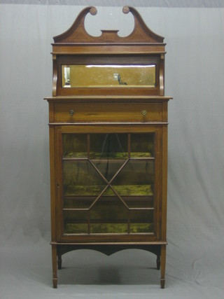 An Edwardian inlaid mahogany cabinet, the raised mirrored back with broken pediment above 1 long drawer, the base fitted a cupboard enclosed by astragal glazed panelled doors, raised on square tapering supports 29"