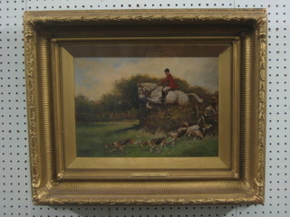 T Ivester Lloyd, oil painting on board "Huntsman Mounted on a Grey Hunter Taking a Fence with Hounds" 9" x 13"