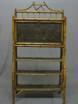 An Art Nouveau bamboo students bureau, the fall front revealing a well fitted interior with stationery rack above 3 shelves 26"