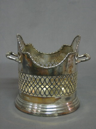 A circular pierced silver plated twin handled soda siphon holder 5"