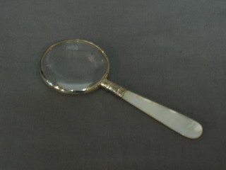 A magnifying glass with mother of pearl handle