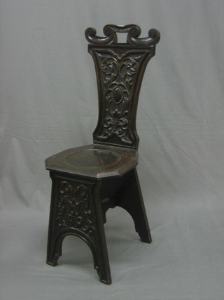 A Victorian carved oak hall chair with carved shaped back and solid seat