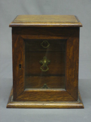 A Victorian oak pedestal collector's/trinket cabinet, the interior fitted 3 shelves enclosed by a glazed panelled door 7 1/2"