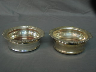 A pair of modern circular silver bottle coasters 7"