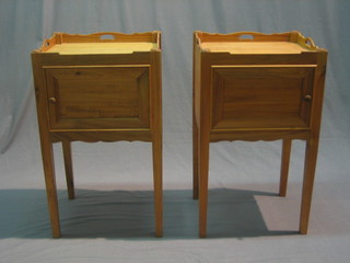 A pair of Georgian style  mahogany tray top bedside cabinets enclosed by panelled doors, raised on square tapering supports 17 1/2" 