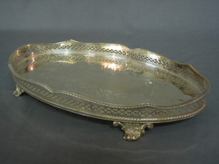 An oval silver plated galleried tray raised on 4 supports 13"