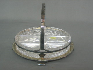 A circular silver plated hors d'eouvres dish with scroll feet complete with glass liner