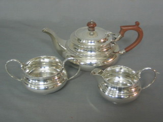 A circular silver 3 piece tea service comprising teapot, twin handled sugar bowl and milk jug with Grecian Key decoration, Sheffield 1921 by Mappin & Webb 34 ozs