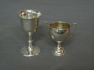 A silver goblet shaped trophy cup and a silver twin handled trophy cup, 2 ozs