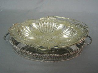 An oval silver plated twin handled galleried tea tray 12", an embossed oval cake basket with swing handle 12"