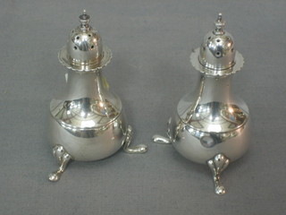 A pair of Georgian style silver pepperettes, raised on hoof feet, Birmingham 1914, 3 ozs