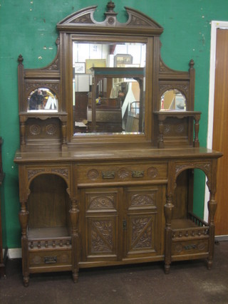 A Victorian carved oak sideboard, the raised back with broken pediment and fitted a rectangular plate mirror flanked by a pair of mirrors, the base fitted 1 long drawer with cupboard and pair of niches, 61"