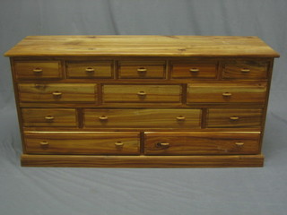 A rectangular Eastern hardwood chest fitted numerous drawers, raised on a platform base 48" 