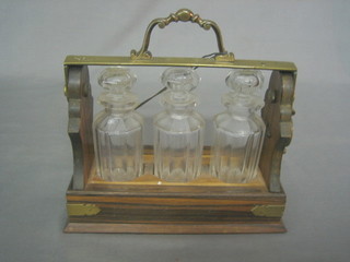 An  oak and silver plated Betjeman patent 3 bottle liqueur tantalus