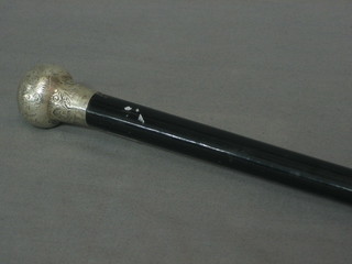 An ebonised walking cane with silver knob