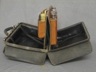A Victorian leather vanity case containing 5 cut glass dressing table jars with silver lids, Birmingham 1899