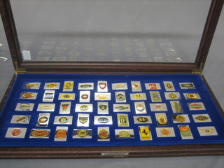 50 silver and enamelled ingots decorated car emblems together with information book, cased