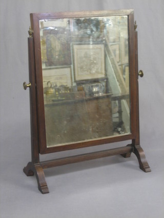 A rectangular plate dressing table mirror contained in an inlaid mahogany swing frame 16"