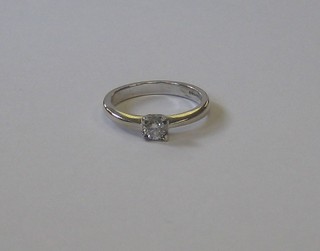 An 18ct white gold solitaire dress ring set a diamond