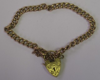 A 9ct gold curb link bracelet with heart shaped padlock clasp