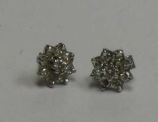A pair of ear studs set white stones