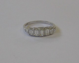 A lady's 18ct white gold dress ring set 5 square cut diamonds with baguette cut diamonds to the shoulders, approx 1.05ct
