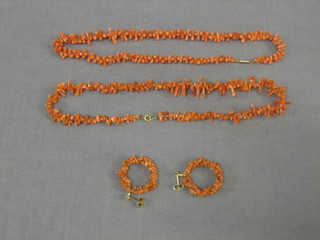 A string of coral twig beads and a pair of matching earrings