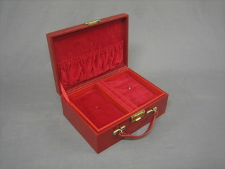 A red leather effect finished jewellery case with hinged lid 10"