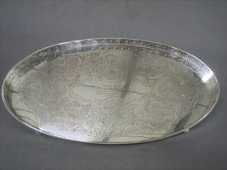 An oval silver plated galleried tea tray, inscribed and raised on 4 bun feet 20"
