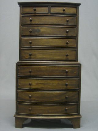 A reproduction Georgian style mahogany bow front apprentice chest on chest, upper section fitted  2 short and 4 long drawers, the base fitted 4 long drawers, raised on bracket feet 12"