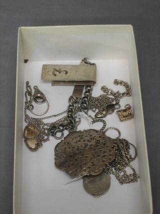 A silver identity bracelet, a silver darts medallion, a silver money clip and a small quantity of various silver costume jewellery