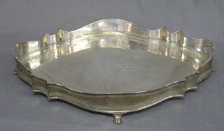 A handsome twin handled shaped galleried tray raised on 4 supports, London 1907, approx 8lbs,