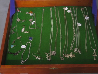 A case containing various silver necklaces
