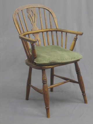 An 18th/19th Century elm stick back carver chair on turned supports