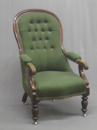 A William IV mahogany open arm chair, upholstered in green material and raised on turned supports
