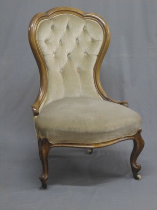 A Victorian bleached mahogany show frame nursing chair upholstered in mushroom coloured material, raised on cabriole supports