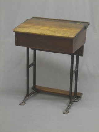An old elm school desk with hinged lid, raised on iron supports 24"