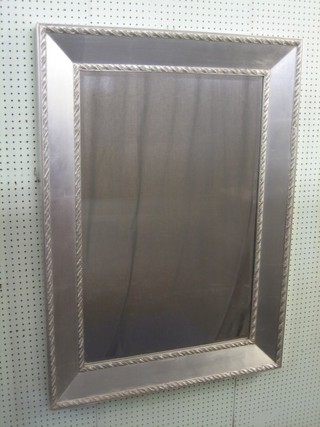A rectangular bevelled plate wall mirror in a silver coloured frame 45" x 33"