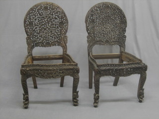 A pair of Burmese pierced and carved hardwood chairs, raised on cabriole supports