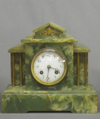 A Victorian French 8 day striking mantel clock with enamelled dial and Arabic numerals contained in a green marble case