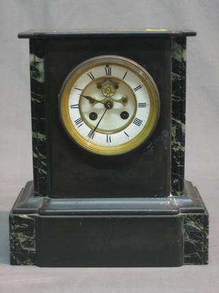 A Victorian French 8 day striking mantel clock with Roman numerals and visible escapement contained in a black 2 colour marble case
