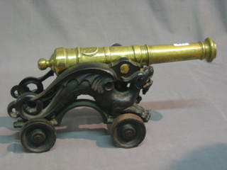 A 19th/20th Century brass canon with 15" barrel, raised on an iron trunion in the form of a dragon