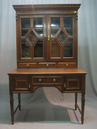 A Victorian simulated rosewood side cabinet, the raised back fitted shelves enclosed by astragal glazed panelled doors above 3 long drawers, the base fitted 1 long drawer flanked by a pair of cupboards raised on square tapering supports 43"